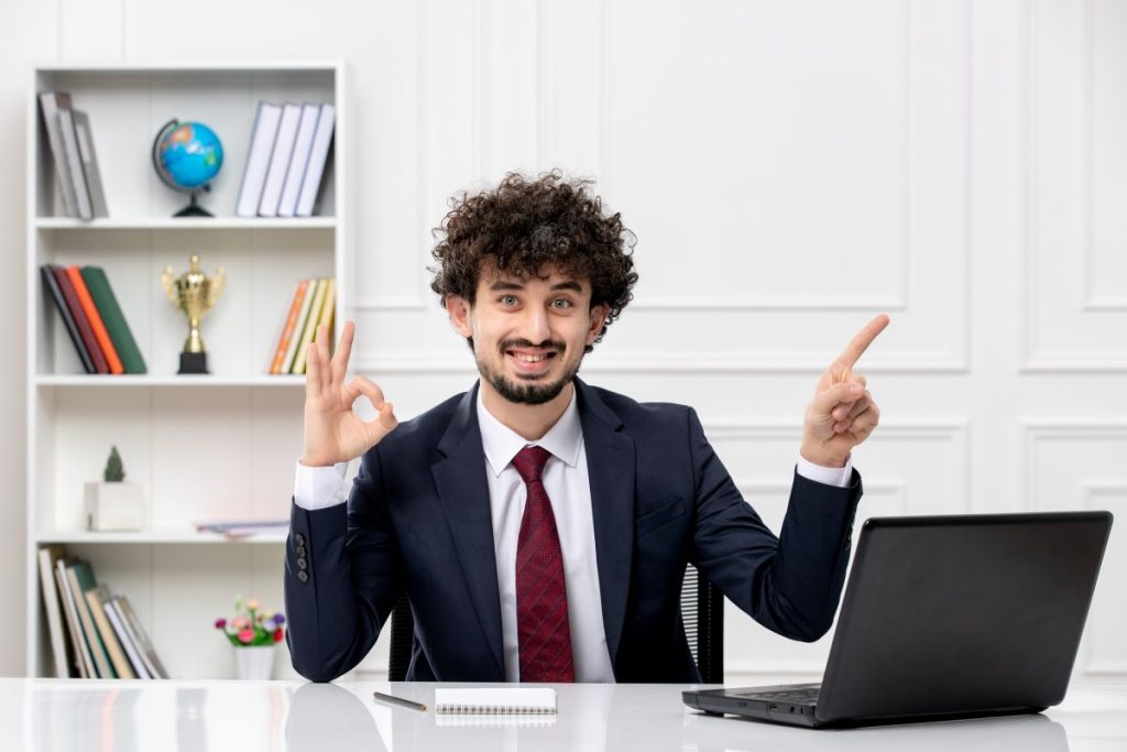 customer service curly brunette young man office suit red tie with laptop happy smiley